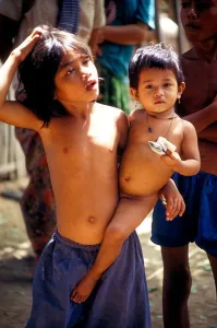 Khmer Prints: Young Cambodian girl carrying a toddler