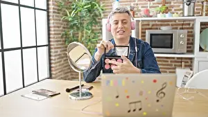 Applying Prints: Young caucasian man recording make up video tutorial at dinning room