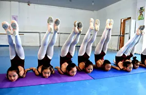 Summer Vacation Prints: Young Chinese girls practice dancing skills during a training session at Huxiao Dance School in Bozhou city