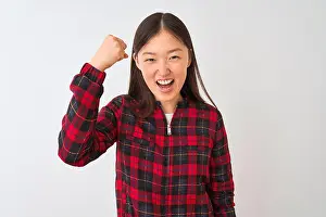 Fist Prints: Young chinese woman wearing casual jacket standing over isolated white background angry