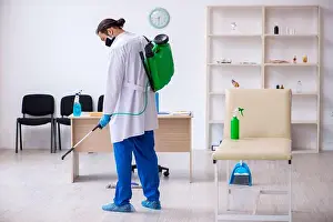 Hygienic Prints: Young contractor disinfecting clinic in pandemic concept