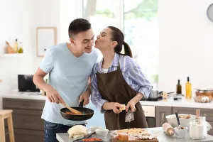 Stir Prints: Young couple cooking together in kitchen