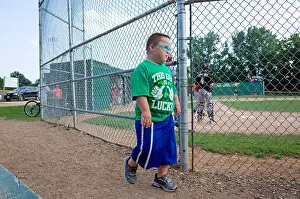 Youngster Prints: Young Down's Syndrome boy wearing his This Guy is Lucky Irish t-shirt at the ball game