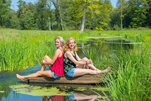 Summer Day Prints: Two young dutch women sit at water in nature