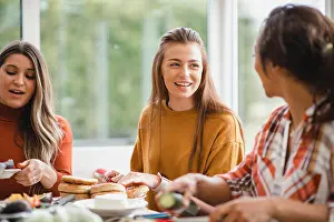 Weekend Activities Prints: young female adult talking to her friend while having a healthy lunch
