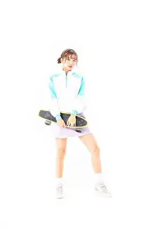 Sneakers Prints: A young female college student skateboarding​