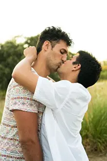 Kiss Prints: A young gay couple kissing in the open air