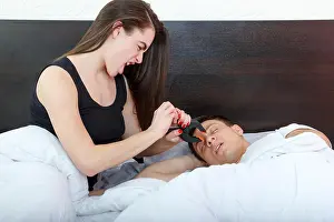 Awake Prints: Young girl being angry on snoring boyfriend