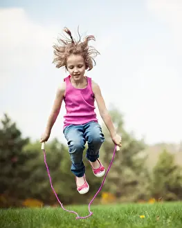 Pre Teen Prints: Young girl skipping in park