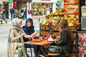 Eurasia Prints: Three young girls eating at a Felafal and Humus outdoor fast food restaurant in Sultanahmet