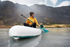 Surfboard Prints: Two young girls walks on stand up paddle boards at mountain lake