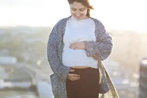 Contentment Prints: Young happy pregnant woman outdoor autumn day on city background