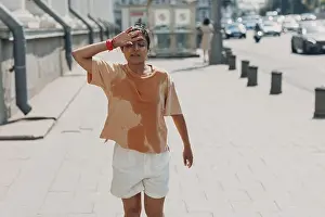 Quick Prints: Young indian woman runner jogging in wet sweaty t-shirt at city street
