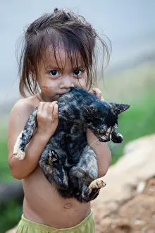 Developing Country Prints: Young Laos girl playing with a cat
