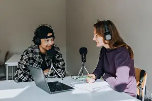 High School Prints: Young male and female student talking during podcast in classroom