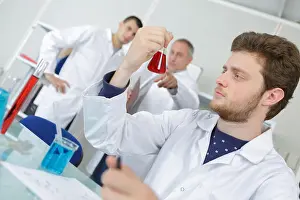 Focused Prints: young male scientist takes an aliquote of liquid sample