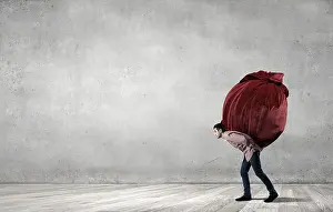 Sack Prints: Young man in casual carrying heavy red bag
