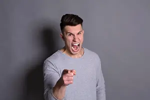 Modeling Prints: Young Man Expressing Anger and Frustration in a Studio Against a Gray Backdrop