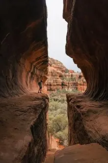 Southwestern Prints: Young man hiker stands in Subway Cave in Boynton Canyon Sedona Arizona