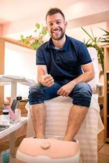 Toes Prints: Young man in a pedicure salon sitting with his feet sunk in a spa bath