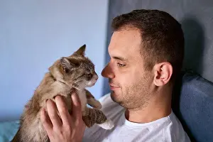 Awake Prints: young man pet a cat in bed, morning routine