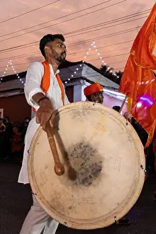 Hindu Festival Prints: Young man playing dhol for Shigmo parade at Ponda, Goa