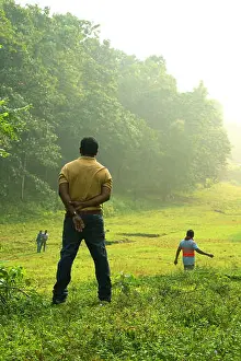Turned Prints: Young man pose and turning back upon camera with a beautiful green scenery of park on background
