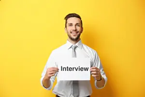 Vacancy Prints: Young man posing with paper on yellow background