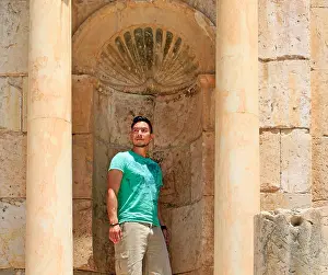 Eurasian Prints: Young man posing as a statue in the Roman ruins of Jerash, Jordan