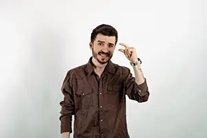 Explaining Prints: Young man smiling confident wearing casual clothes posing isolated over white background looking at camera showing