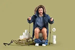 Problem Prints: Young man with walking poles sitting on toilet bowl against green background