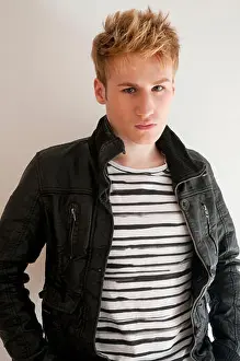 Stare Prints: Young man wearing black leather jacket and striped T-shirt, looking at the camera