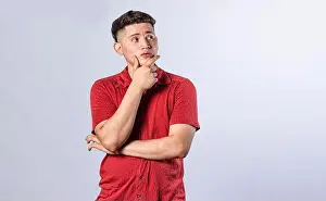 Descent Prints: Young man wondering with his hand on his chin on an isolated background
