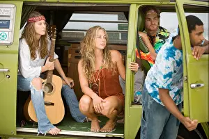 Contentment Prints: Young men and women in hippie fashion sitting in van with guitar