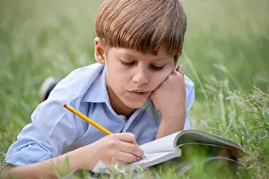 Pre Adolescent Prints: Young people and education, school child doing homework