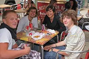 Boulevard Prints: Young people enjoying an al Fresco outdoor break at pavement café on Victor Hugo Boulevard Nimes France