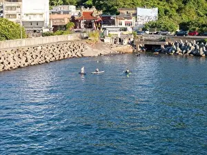 Surfboard Prints: Young people enjoying marine sports such as SUP in Keelung City, Taiwan. September 2024