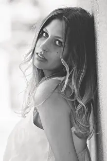 Lean Prints: Young, pretty woman with long hair, leaning against a wall