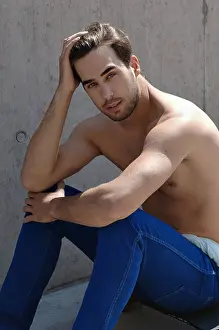 Airy Prints: Young shirtless skater in front of a concrete wall, sitting on his skateboard