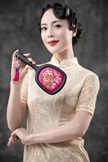 Beautiful Woman Prints: Young smiling woman in retro-style oriental clothes posing with mirror