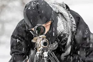 Snowstorm Prints: A young soldier trains with his weapon in a harsh snowstorm