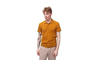 Redhead Prints: young stylish guy with red hair dressed in a mustard-colored T-shirt looks surprised