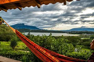 Chill Prints: A young traveler enjoying the sunset while overlooking Laguna de Yahuarcocha and Imbabura in Ibarra