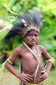 Papua New Guinea Prints: young tribal boy with head dress of feathers, Papua New Guinea