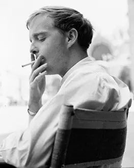 Young Truman Capote moking a cigarette at a cafe in Venice