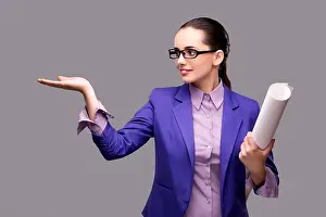 Pulling Prints: Young woman architect on gray background