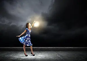 Enchanting Prints: Young woman in blue dress with lantern