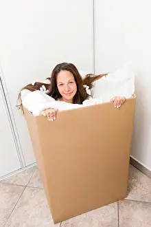 Relocation Prints: Young woman in a box with packing material