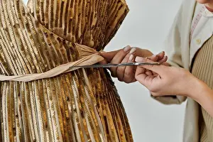 Reuse Prints: A young woman in casual attire upcycling clothes, cutting fabric with scissors