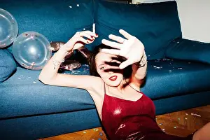 Hangover Prints: Young woman celebrating her 21st birthday illuminated with hard flash light